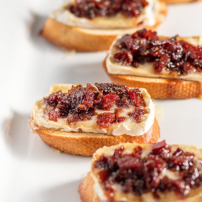 Bacon Jam and Brie Crostini on a White Plate Stock Photo - Image of ...