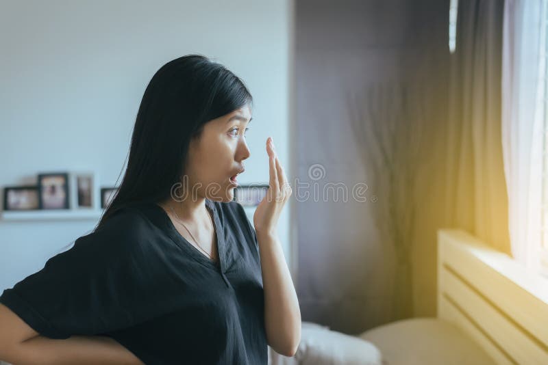 Bad smell,Asian woman covering her mouth and smell her breath with hands stock images Bad smell,Asian woman covering her mouth and smell her breath with hands stock images