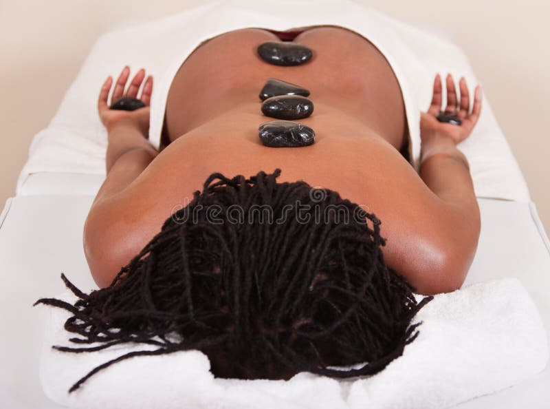 Lifestyle, african american woman having a stone massage treat at the spa. Lifestyle, african american woman having a stone massage treat at the spa