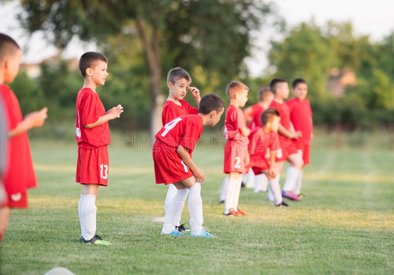 Badine le football du football - joueurs d'enfants s'exerçant avant match