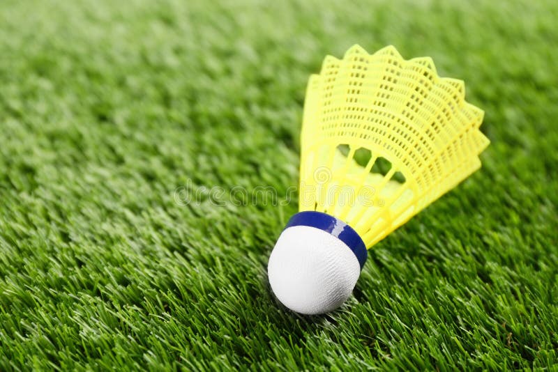 Badminton Shuttlecock on Green Grass Outdoors, Closeup. Space for Text
