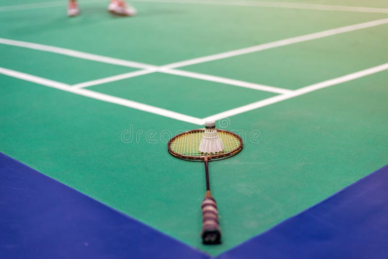 badminton shuttlecock and racket on court