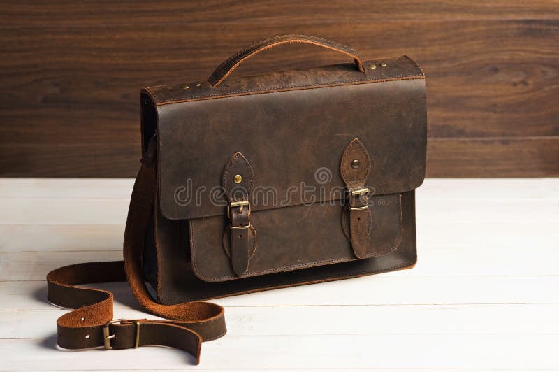 Bag briefcase for businessman men, leather brown bag on a wooden background. Men`s fashion, accessory, business background. royalty free stock image Bag briefcase for businessman men, leather brown bag on a wooden background. Men`s fashion, accessory, business background. royalty free stock image