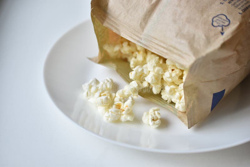 A Bag of Popcorn Open on a Plate in the Kitchen Stock Photo Image of