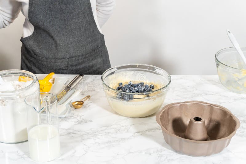 Delicately transferring the cake batter into the pre-greased bundt cake pan, setting the stage for a successful baking process. Delicately transferring the cake batter into the pre-greased bundt cake pan, setting the stage for a successful baking process.