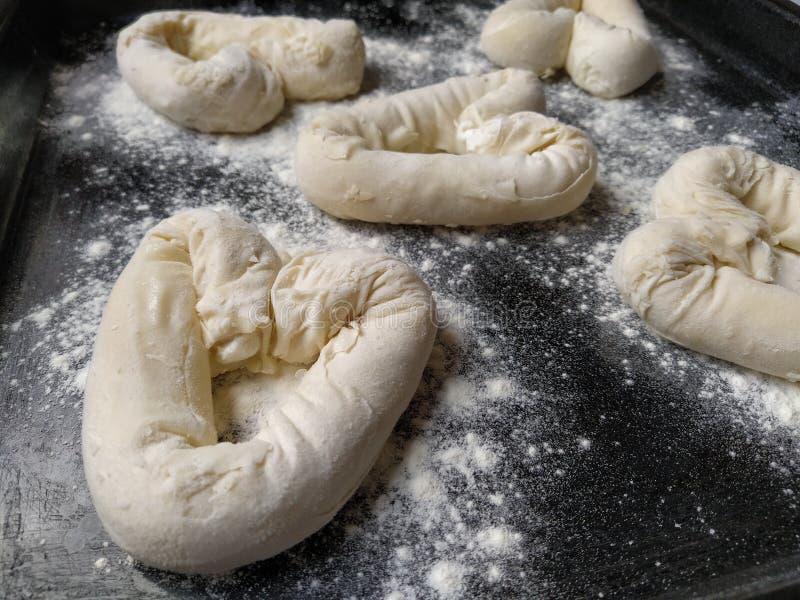 Bagels in the Form of Hearts Made of Dough, Sprinkled with Flour, Lying