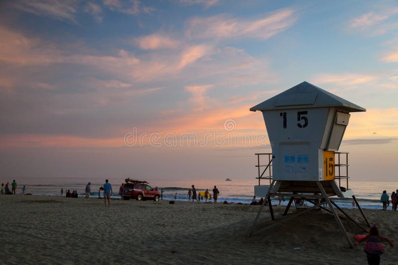 MISSION BAY, CA-USA-8 JULY 2018- Sunset at Mission Bay Beach. Lifeguard tower 15 in the foreground with a Lifeguard truck on the beach. Lifeguards are leaving for the evening and suggest everyone leaves the water. MISSION BAY, CA-USA-8 JULY 2018- Sunset at Mission Bay Beach. Lifeguard tower 15 in the foreground with a Lifeguard truck on the beach. Lifeguards are leaving for the evening and suggest everyone leaves the water