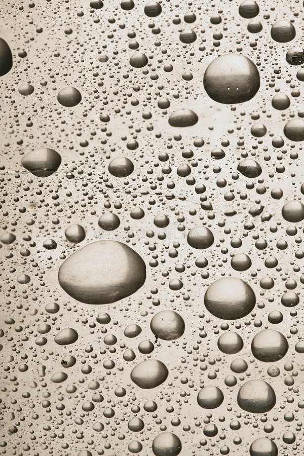 Water or rain drops on a silver metal background. Water or rain drops on a silver metal background.