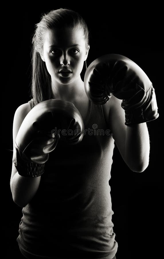 Low key artistic studio shot of a female boxer. Low key artistic studio shot of a female boxer