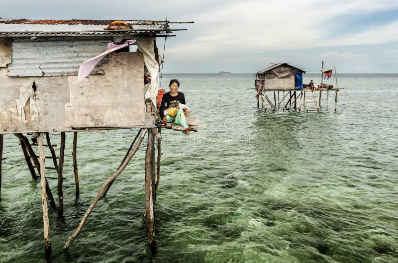 Bajau tribe mother sitting her wooden house in Sabah Semporna, Malaysia royalty free stock images Bajau tribe mother sitting her wooden house in Sabah Semporna, Malaysia royalty free stock images