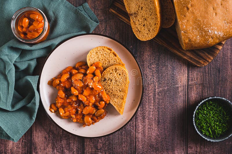 Baked Beans with Vegetables and Rye Bread on a Plate on the Table Top