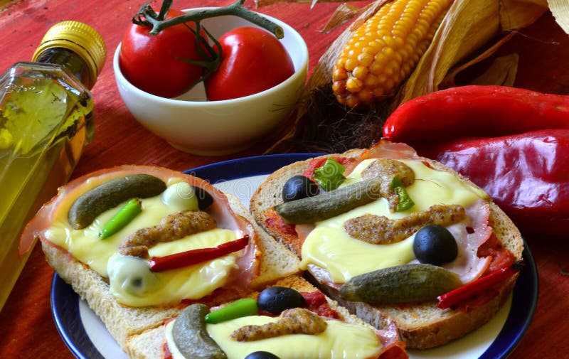 Baked Bread with Ham, Cheese, Mustard, Gherkins and Olives Stock Image