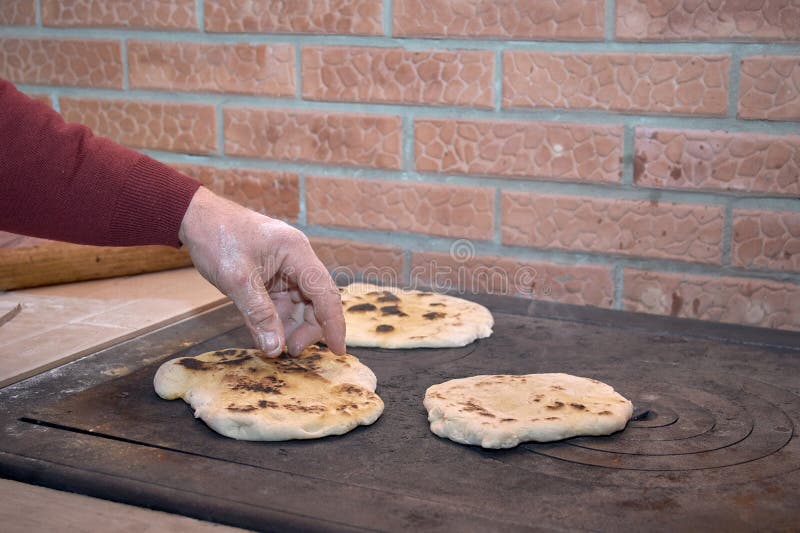 Baked bread on the stove 1 stock photo. Image of hand 276317568