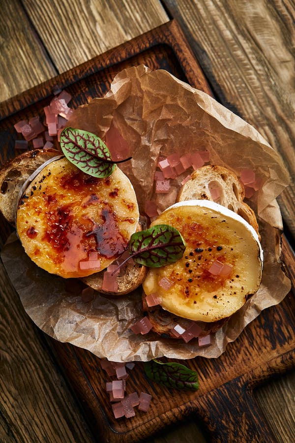 Baked Camembert Cheese with Toasted Bread on Wooden Board Stock Image