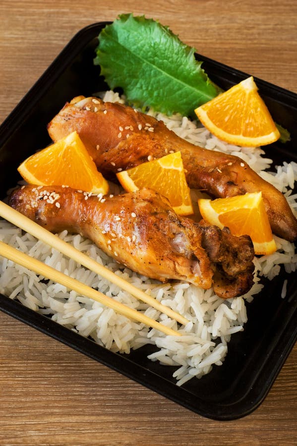 Baked Chicken Legs With Rice And Orange Stock Photo ...