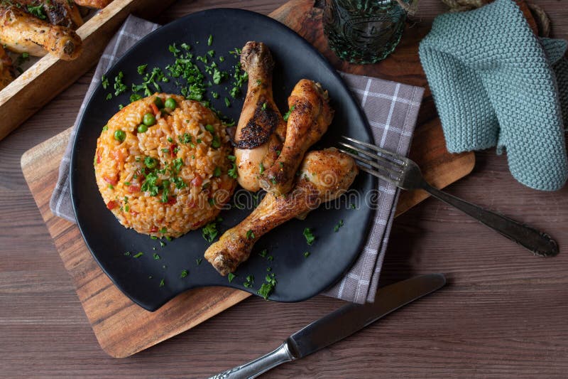 Baked Chicken with Vegetable Rice on a Plate. Cooked with Brown Rice