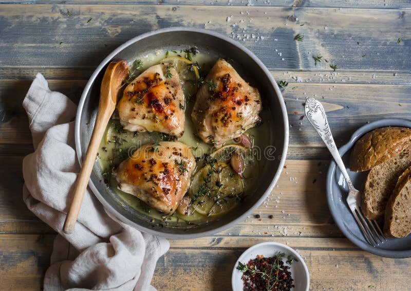 Baked Chicken in White Wine in the Pan. on Rustic Wooden Background