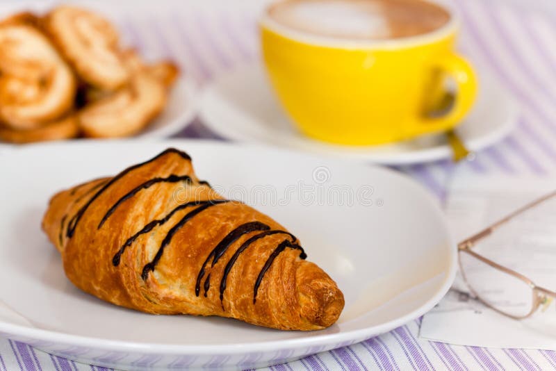 Baked,chocolate croissant ,on white plate