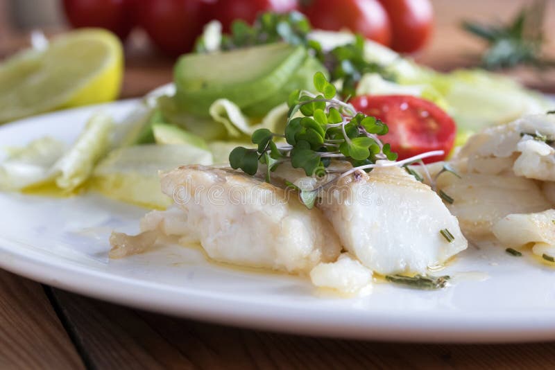 Baked cod fish with fresh microgreens