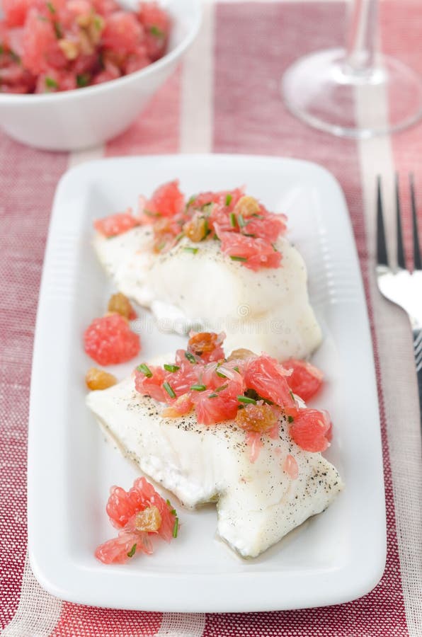 Baked cod with grapefruit salsa stock image