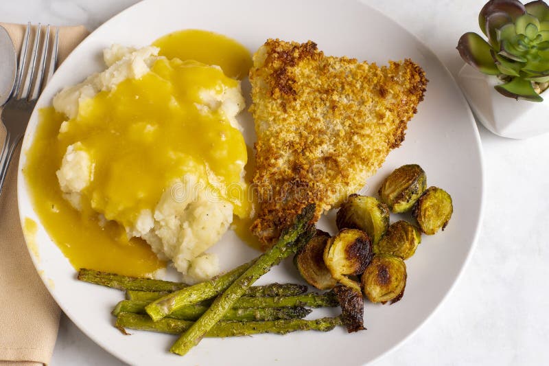 Baked cod served with roasted vegetables royalty free stock photo