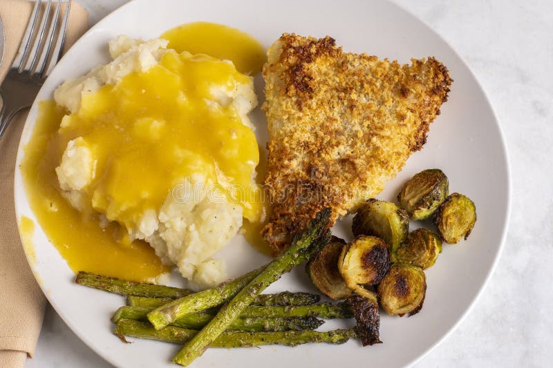 Baked cod served with roasted vegetables stock photos