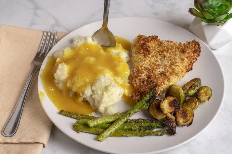 Baked cod served with mash potatoes androasted vegetables stock photography