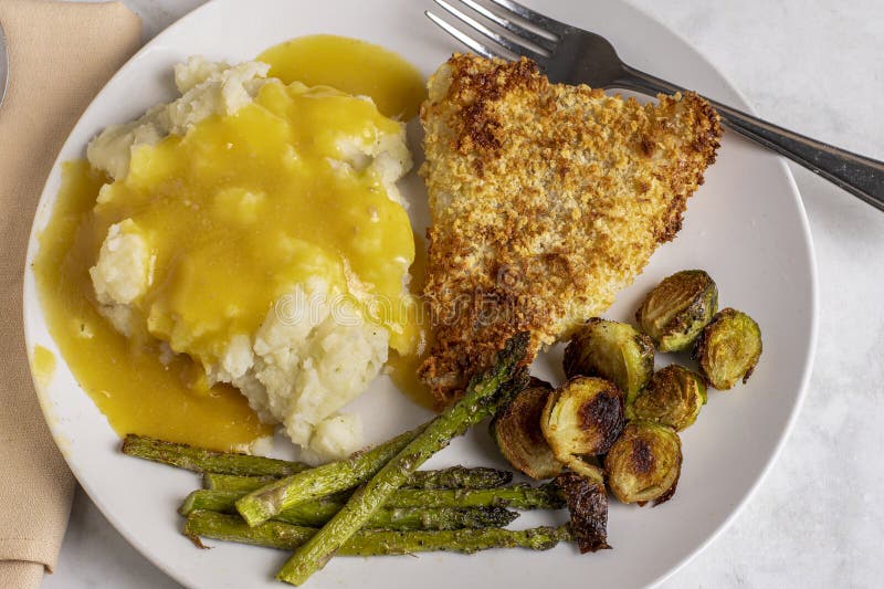 Baked cod served with mash potatoes androasted vegetables royalty free stock photos