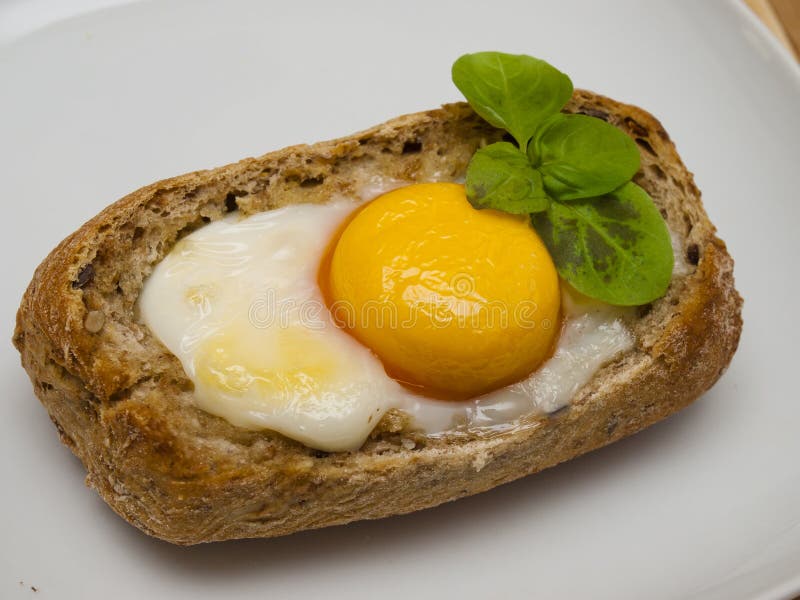 Baked egg in bread bowl stock photo. Image of breakfast 79618404