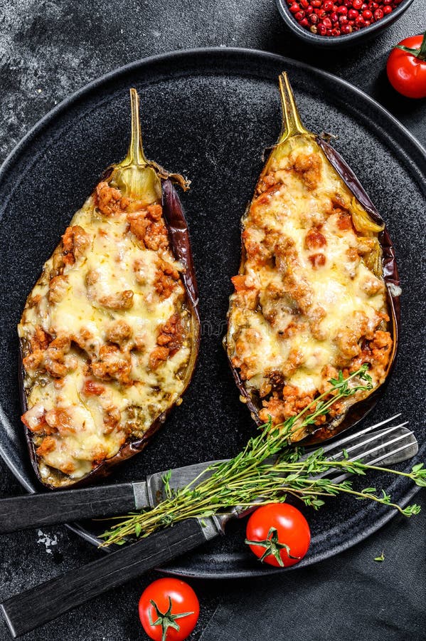 Baked Eggplant with Ground Beef and Cheese. Black Background. Top View