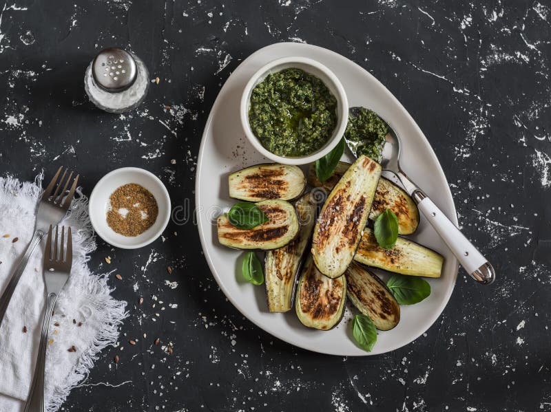 Baked Eggplant and Pesto Sauce. on a Dark Background Stock Photo