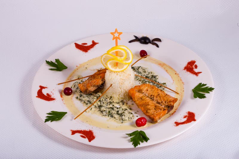Baked fish with white rice and sause decorated lemon royalty free stock photo Baked fish with white rice and sause decorated lemon royalty free stock photo