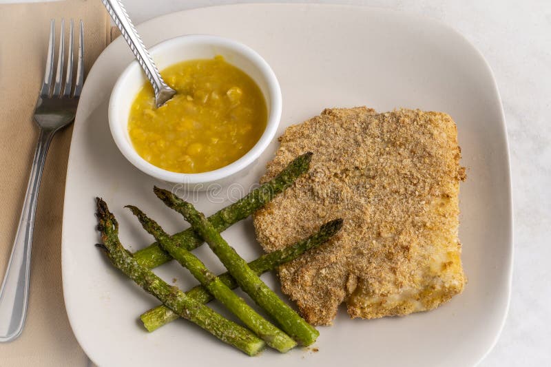 Baked haddock with asparagus and cream corn royalty free stock images
