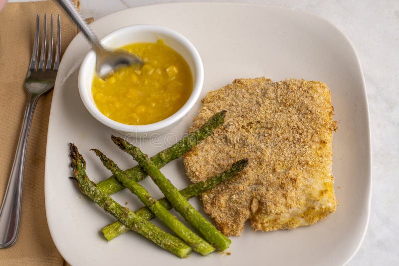 Baked haddock with asparagus and cream corn stock image
