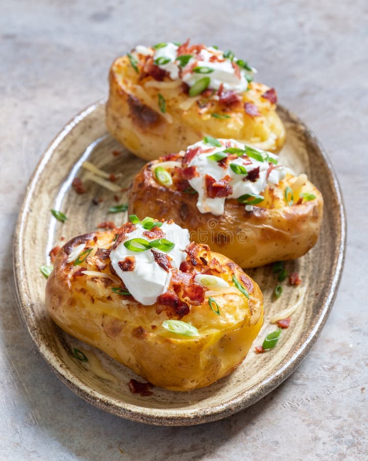 Hot Baked Potato With Cheese, Bacon, Chives And Sour Cream. Stock Image