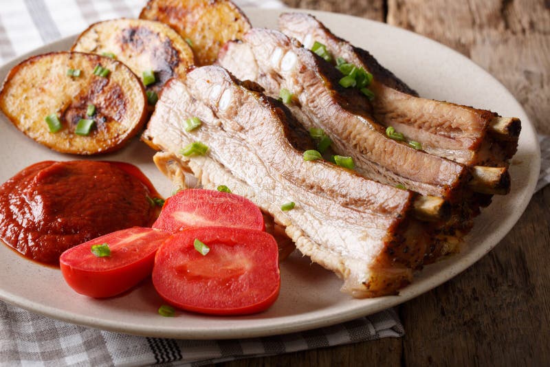 Baked Pork Brisket with Potatoes and Sauce Close Up. Horizontal Stock