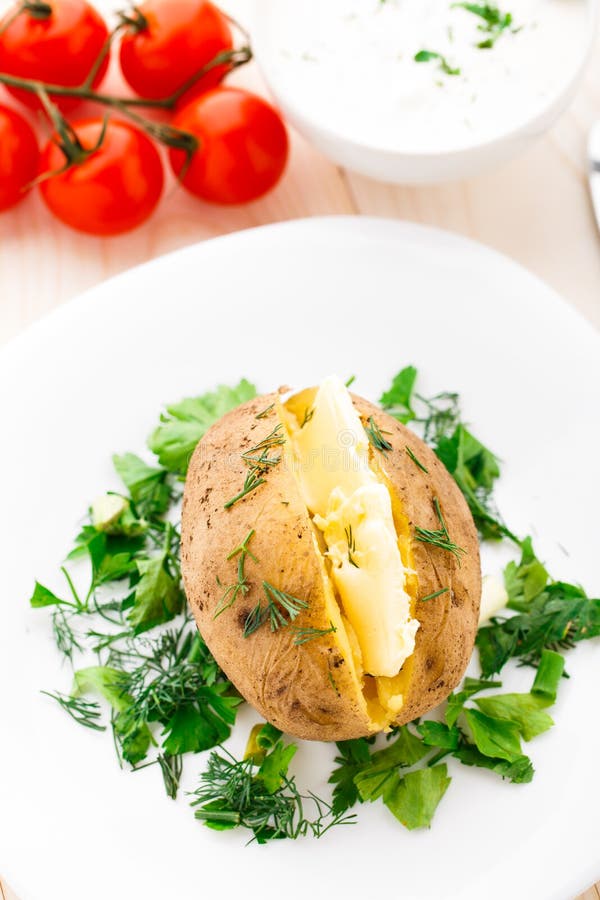 Baked potato with butter stock photo. Image of parsley 34282558