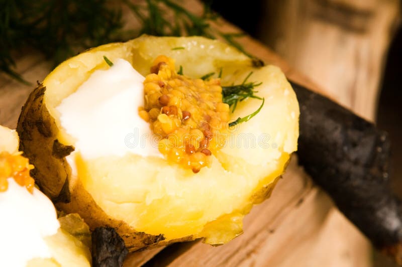 Baked potato with sour cream, mustard and herbs