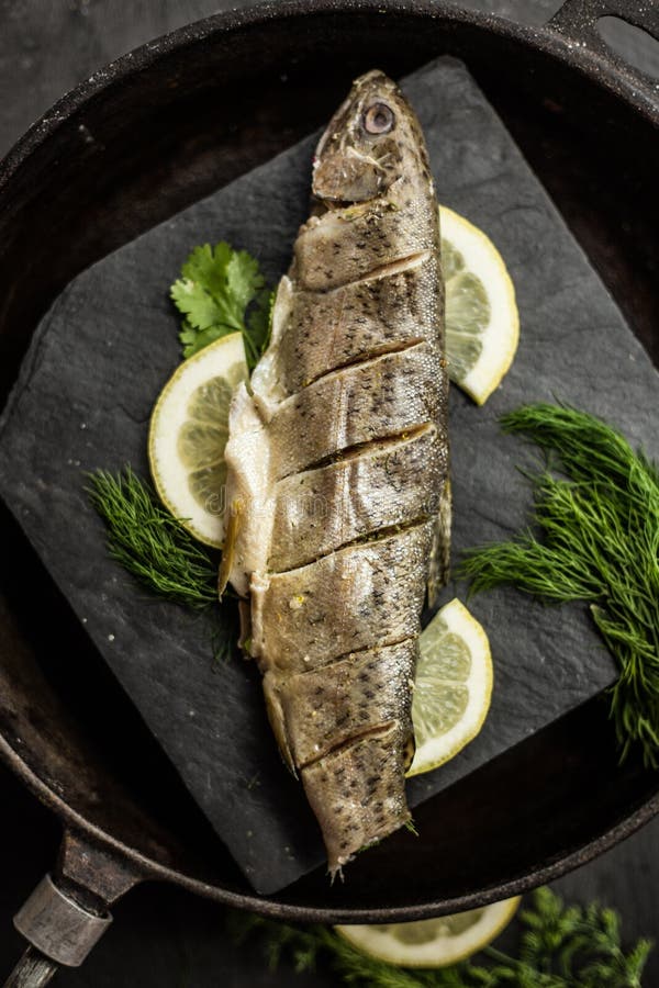 Baked rainbow trout fish with dill and lemon. Restaurant. Seafood royalty free stock images Baked rainbow trout fish with dill and lemon. Restaurant. Seafood royalty free stock images