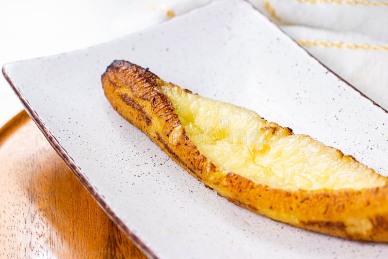 Baked Ripe Plantains with Cheese (Plantain Canoe or Platanos Asados Con Queso) on a plate royalty free stock photo Baked Ripe Plantains with Cheese (Plantain Canoe or Platanos Asados Con Queso) on a plate royalty free stock photo