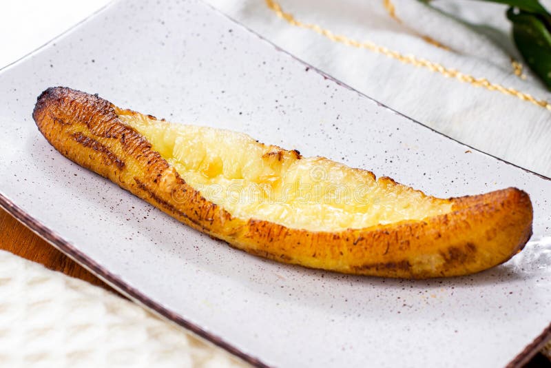 Baked Ripe Plantains with Cheese (Plantain Canoe or Platanos Asados Con Queso) on a plate royalty free stock images Baked Ripe Plantains with Cheese (Plantain Canoe or Platanos Asados Con Queso) on a plate royalty free stock images