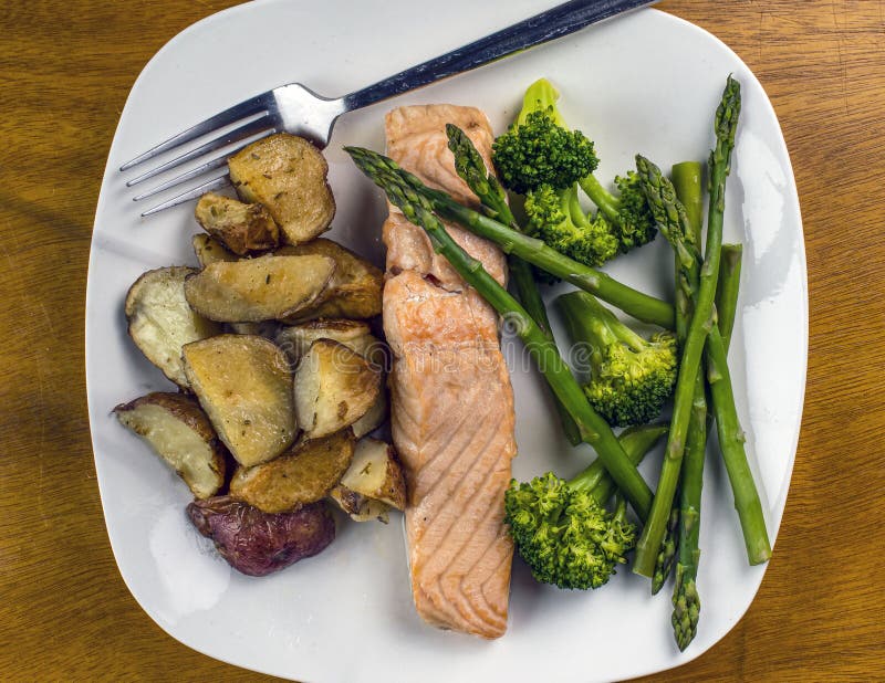 Baked salmon with asparagus and broccoli stock photos