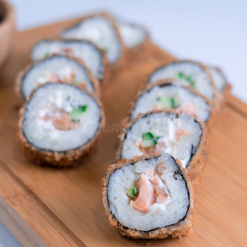 Baked Sushi Rolls. Hot Fried Sushi Roll with Salmon, Avocado and Cheese