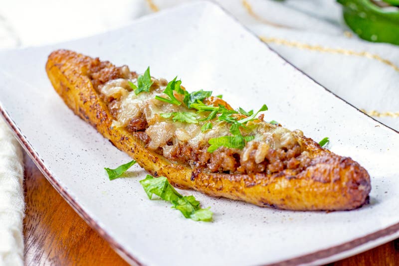 Baked Sweet Ripe Plantain Canoe (Canoas de Platanos Maduros) stuffed with ground meat, cheese and greens royalty free stock photos Baked Sweet Ripe Plantain Canoe (Canoas de Platanos Maduros) stuffed with ground meat, cheese and greens royalty free stock photos