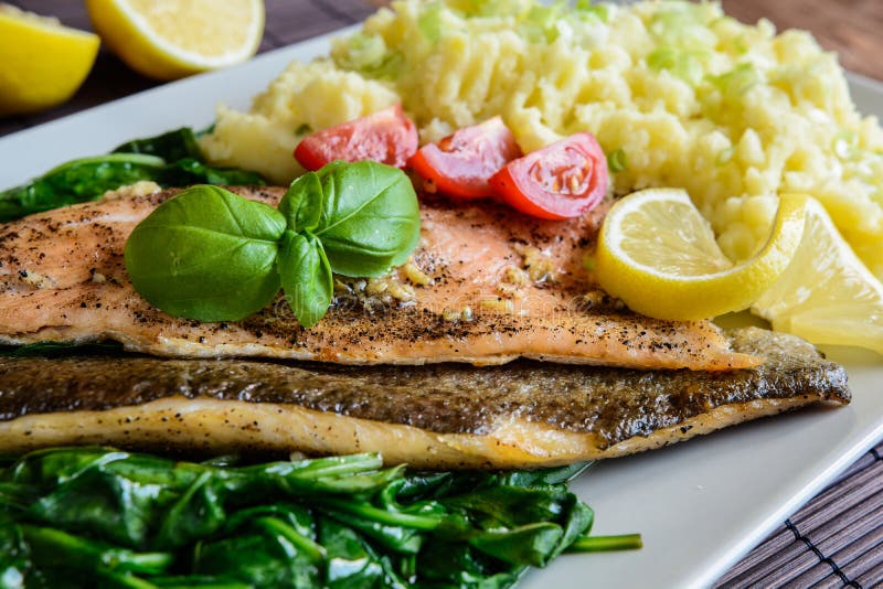 Baked Trout Fillet with Mashed Potatoes and Steamed Spinach Stock Photo