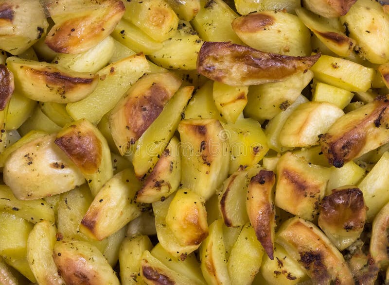Baked Yellow Potatoes with Burnt Edges. Potatoes with Spices Stock