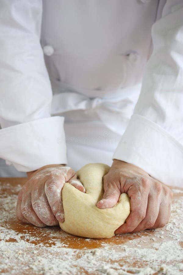 Baker effectuant le pain, malaxant une pâte