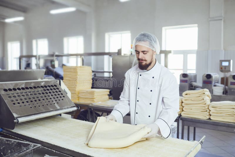 A Baker Makes the Dough on the Equipment in the Bakery Stock Image