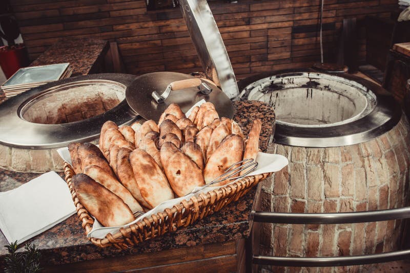 https://thumbs.dreamstime.com/b/baker-making-turkish-pita-bread-tandoor-clay-oven-baking-process-many-fresh-hot-bread-basket-baker-making-turkish-pita-134626497.jpg