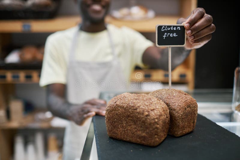 Baker Putting Bread in Showcase stock photo
